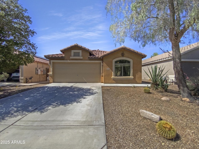 40168 W Sanders Way, Maricopa, AZ 85138 - mediterranean / spanish house with a tile roof, stucco siding, an attached garage, and driveway