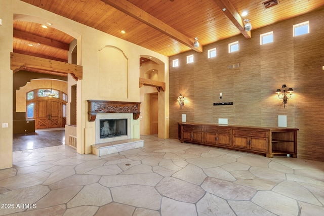 9980 E Charter Oak Rd, Scottsdale, AZ 85260 - unfurnished living room with a high ceiling, plenty of natural light, wooden ceiling, and beam ceiling