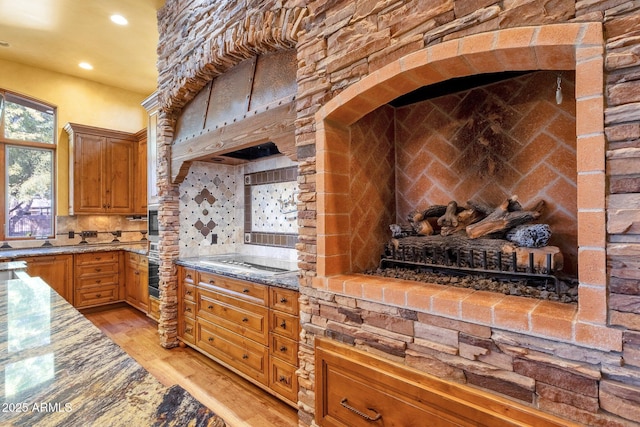9980 E Charter Oak Rd, Scottsdale, AZ 85260 - kitchen with gas cooktop, stone counters, wall oven, light hardwood / wood-style floors, and decorative backsplash