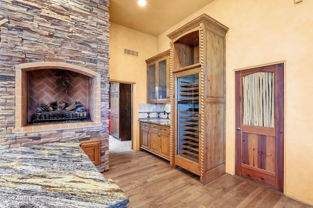 9980 E Charter Oak Rd, Scottsdale, AZ 85260 - kitchen featuring dark stone counters and light wood-type flooring