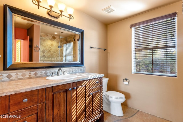 9980 E Charter Oak Rd, Scottsdale, AZ 85260 - bathroom featuring tasteful backsplash, vanity, a wealth of natural light, and toilet