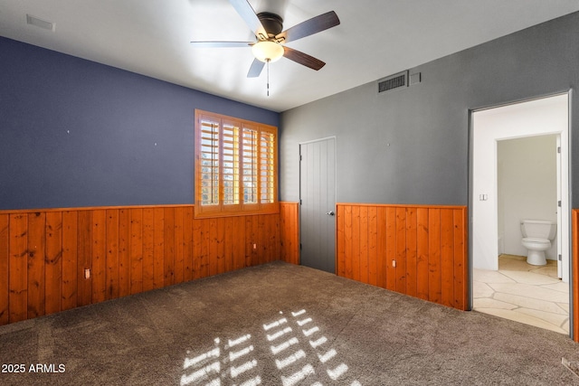 9980 E Charter Oak Rd, Scottsdale, AZ 85260 - carpeted empty room with ceiling fan and wood walls