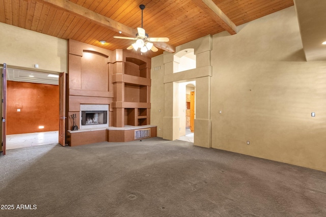 9980 E Charter Oak Rd, Scottsdale, AZ 85260 - unfurnished living room featuring a high ceiling, a large fireplace, wood ceiling, and beam ceiling