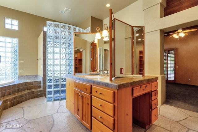 9980 E Charter Oak Rd, Scottsdale, AZ 85260 - bathroom with vanity, tiled tub, lofted ceiling, and ceiling fan