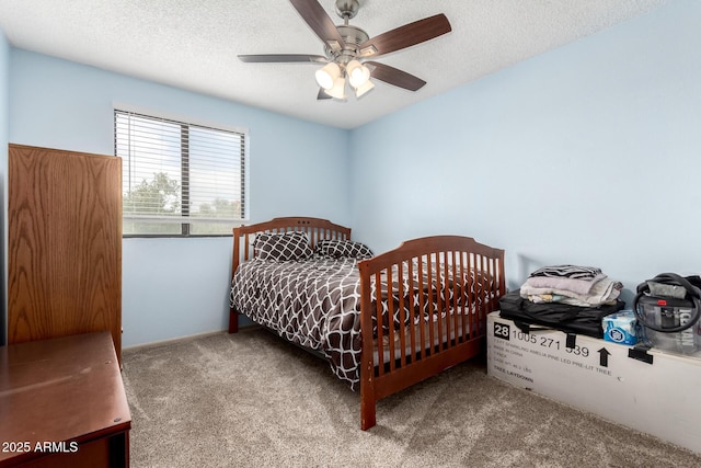 bedroom featuring a textured ceiling, a ceiling fan, and carpet floors