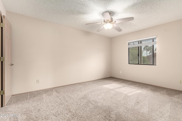 spare room with carpet flooring, a textured ceiling, and a ceiling fan