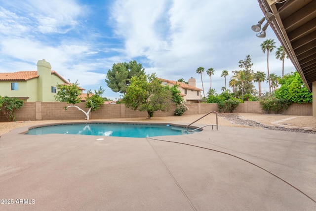 view of swimming pool with a fenced backyard, a fenced in pool, and a patio