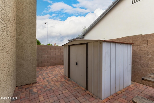 view of shed with a fenced backyard