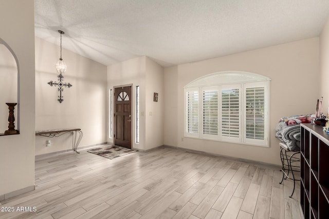foyer featuring wood finished floors and baseboards