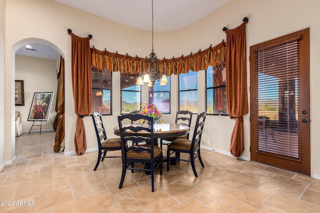 dining space with an inviting chandelier