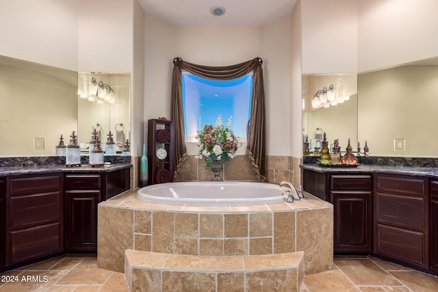 bathroom with tiled bath and vanity