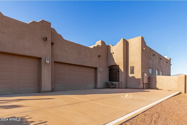 southwest-style home featuring a garage