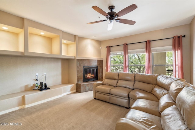 unfurnished living room with a ceiling fan, baseboards, recessed lighting, light carpet, and a tiled fireplace