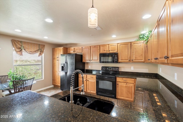 kitchen featuring black appliances, recessed lighting, baseboards, and a sink