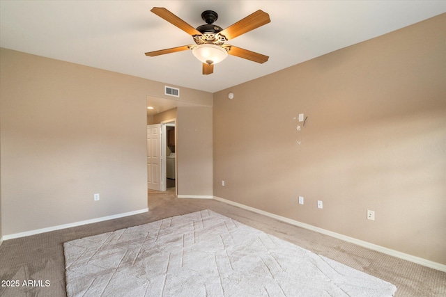 carpeted spare room with a ceiling fan, baseboards, and visible vents