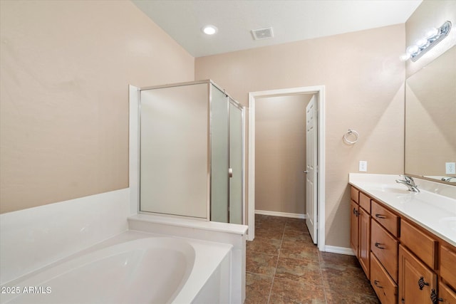 full bathroom with visible vents, double vanity, a stall shower, a bath, and a sink