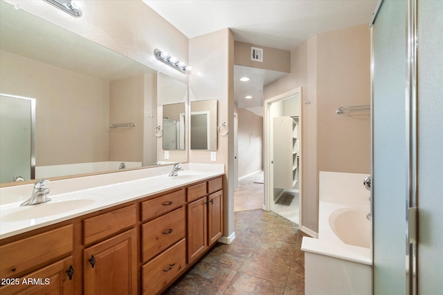 full bathroom with a garden tub, double vanity, a shower with door, and a sink