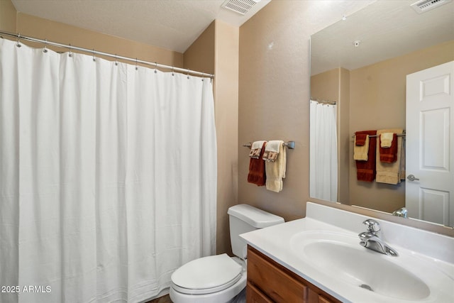 full bathroom featuring visible vents, toilet, and vanity