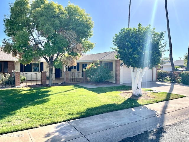 view of front of home featuring a garage and a front lawn