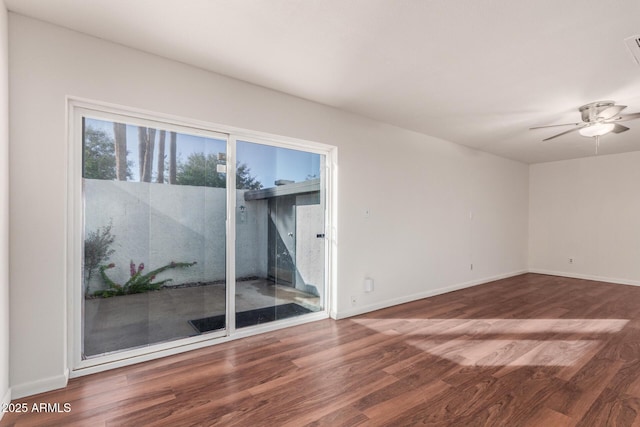 unfurnished room featuring ceiling fan, baseboards, and wood finished floors