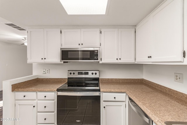 kitchen with visible vents, white cabinets, ceiling fan, stainless steel appliances, and light countertops