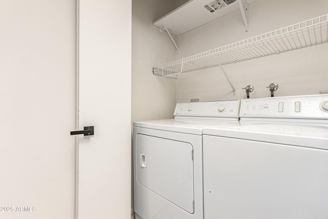 washroom featuring washing machine and dryer