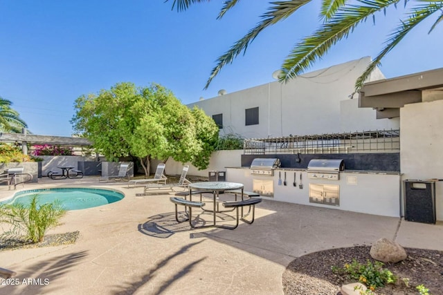 view of swimming pool featuring a fenced in pool, a patio area, a grill, and area for grilling