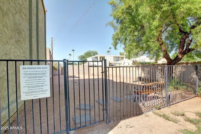 view of gate with fence