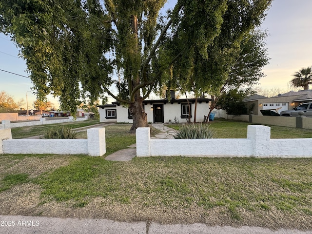 view of front of property with a front lawn and fence