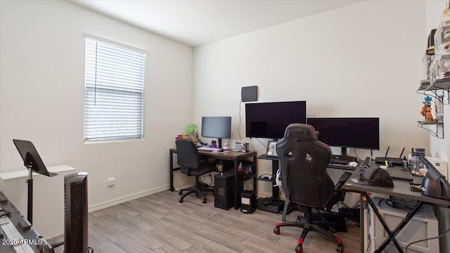 office with baseboards and light wood finished floors