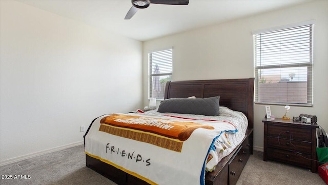 bedroom with ceiling fan, baseboards, and carpet floors