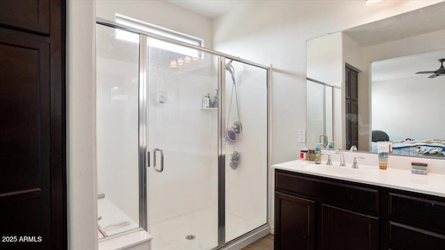 bathroom featuring a shower stall, vanity, and ceiling fan