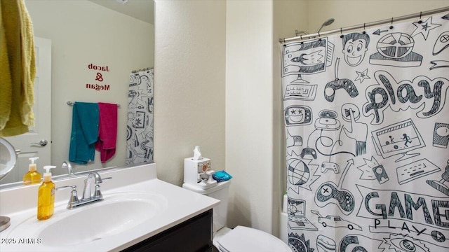 bathroom featuring toilet and vanity