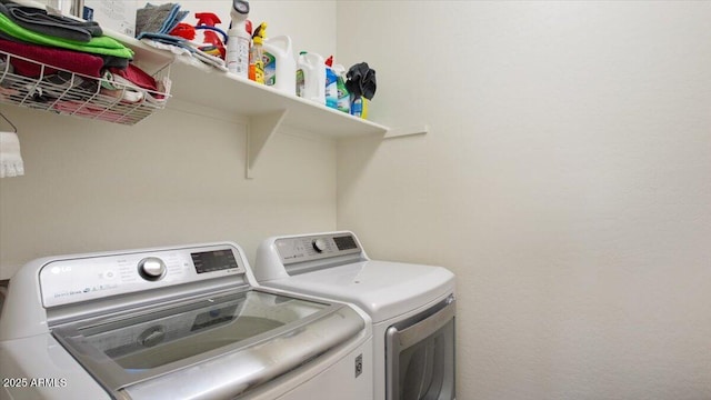 washroom featuring laundry area and separate washer and dryer