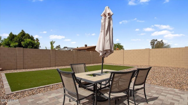 view of patio featuring outdoor dining area and a fenced backyard