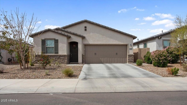 view of front of home with fence, driveway, stucco siding, a garage, and stone siding
