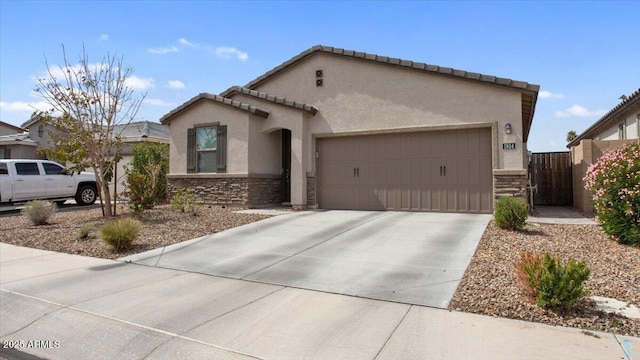 view of front facade featuring fence, driveway, stucco siding, a garage, and stone siding