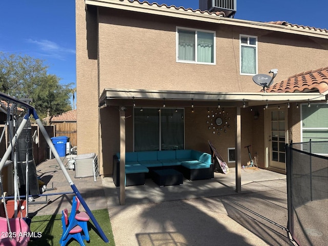 rear view of property with a patio and an outdoor hangout area