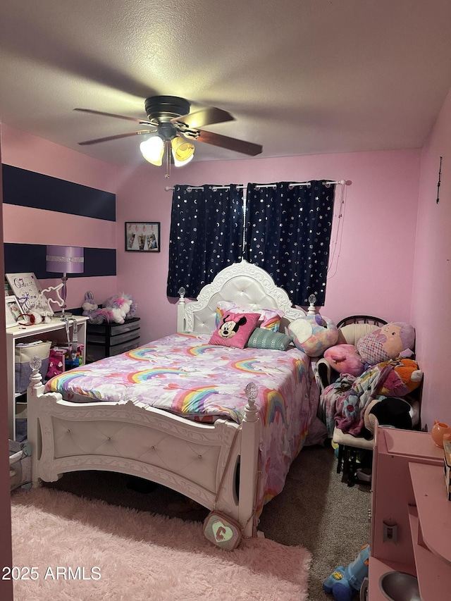 carpeted bedroom with a textured ceiling and ceiling fan