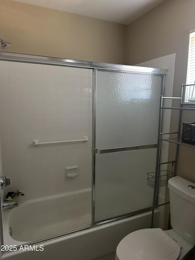 bathroom with toilet and enclosed tub / shower combo