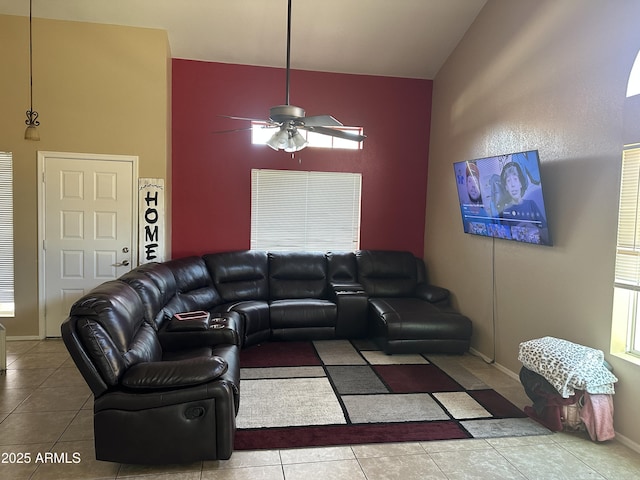 living room with ceiling fan, light tile patterned floors, and high vaulted ceiling