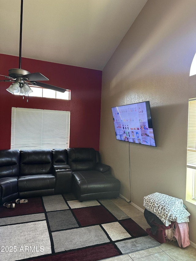 living room with vaulted ceiling, ceiling fan, and light tile patterned flooring