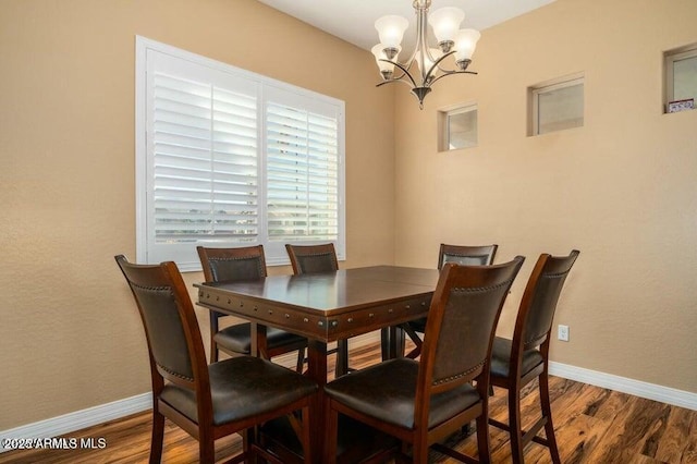 dining space featuring an inviting chandelier and hardwood / wood-style floors