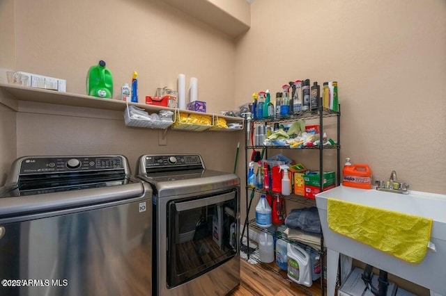 laundry room featuring hardwood / wood-style flooring and washing machine and dryer