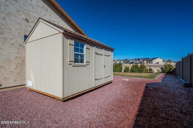 view of property exterior with a shed