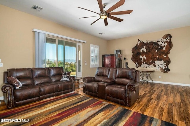 living room featuring hardwood / wood-style flooring and ceiling fan