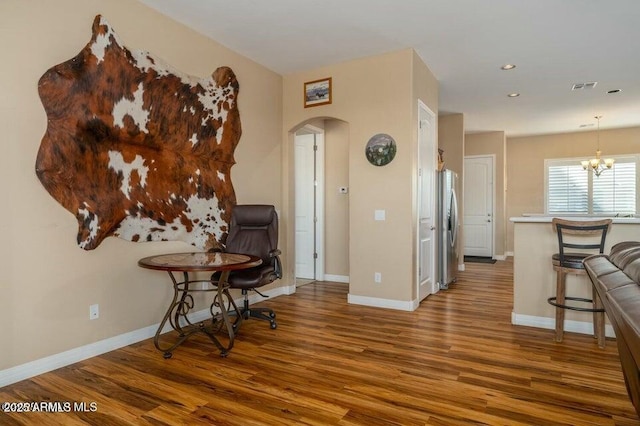 living area featuring an inviting chandelier and hardwood / wood-style floors