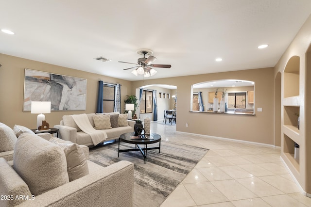 tiled living room featuring ceiling fan