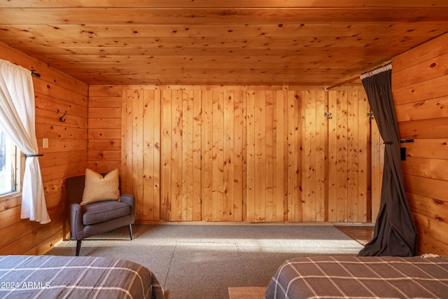 unfurnished bedroom with carpet flooring, wood ceiling, and wooden walls