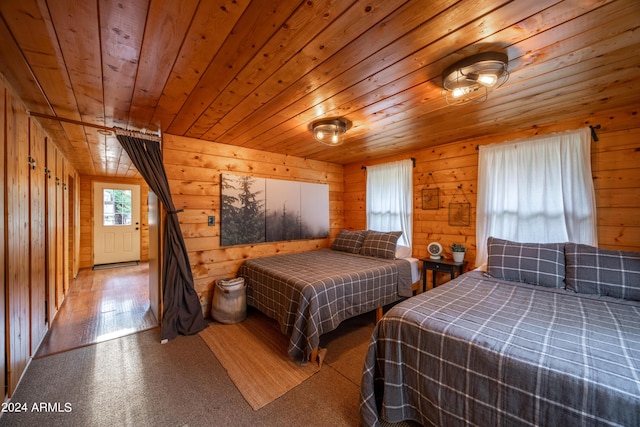 bedroom featuring wooden ceiling, wood finished floors, and wooden walls